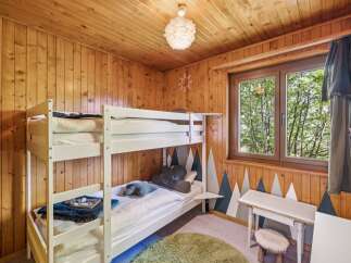 This charming children's bedroom features a cozy bunk bed, perfect for sleepovers or siblings.