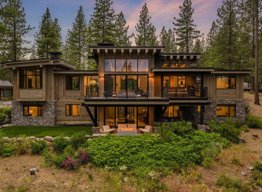 Experience luxury mountain living in this stunning modern home, nestled amongst towering pine trees.