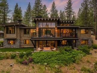 Experience luxury mountain living in this stunning modern home, nestled amongst towering pine trees.