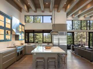 Experience modern mountain living in this stunning open-concept kitchen and living area.