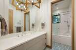 Experience modern luxury in this stunning bathroom featuring a double vanity with sleek chrome fixtures and ample storage.