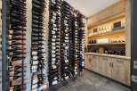 Experience the ultimate wine connoisseur's dream with this custom-built wine cellar, featuring extensive vertical wine racks capable of holding hundreds of bottles.