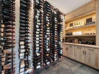 Experience the ultimate wine connoisseur's dream with this custom-built wine cellar, featuring extensive vertical wine racks capable of holding hundreds of bottles.