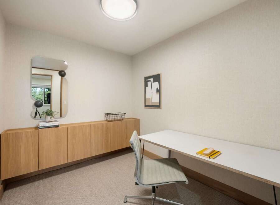 This modern office space features a sleek white desk with a minimalist chair, perfect for productivity.