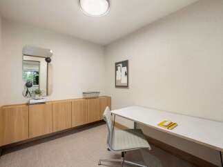 This modern office space features a sleek white desk with a minimalist chair, perfect for productivity.