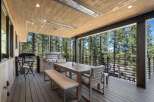 Enjoy outdoor living at its finest on this expansive deck, complete with a built-in grill and comfortable dining set.