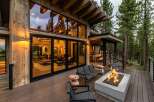 Experience luxury mountain living with this stunning modern cabin featuring expansive floor-to-ceiling windows that showcase breathtaking forest views.