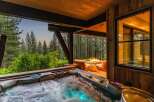 Indulge in ultimate relaxation with this luxurious outdoor living space, featuring a steaming hot tub perfect for unwinding.