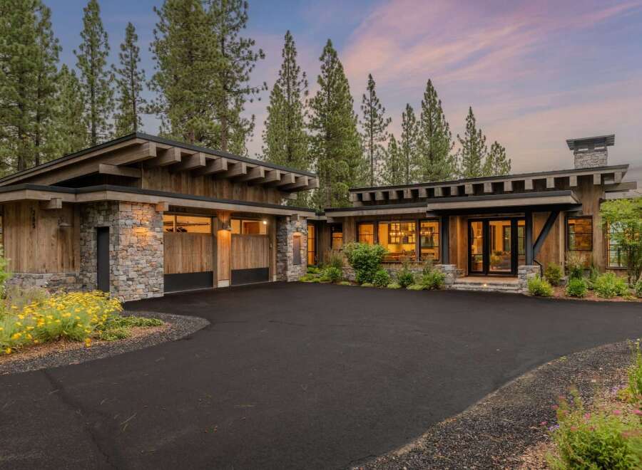 Experience modern mountain living in this stunning home, featuring a striking combination of natural wood and stone accents.