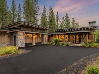 Experience modern mountain living in this stunning home, featuring a striking combination of natural wood and stone accents.
