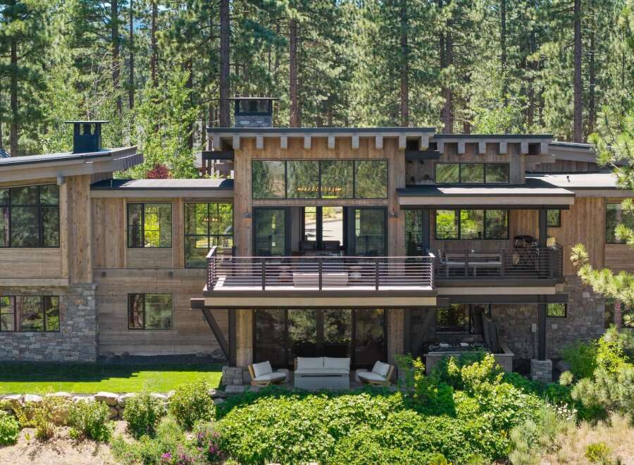 Experience luxury mountain living in this stunning modern home, nestled amongst towering pine trees.