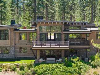 Experience luxury mountain living in this stunning modern home, nestled amongst towering pine trees.