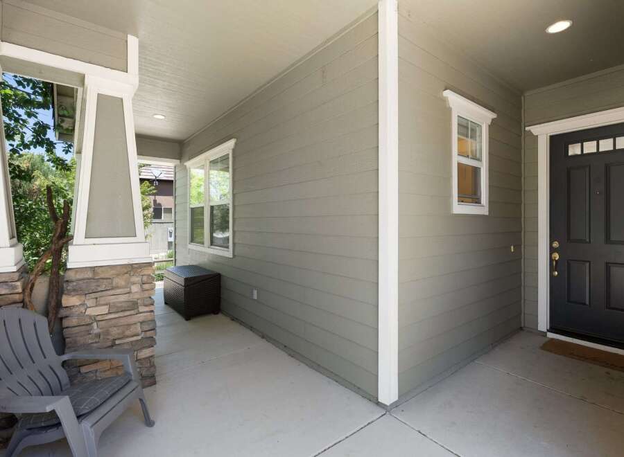 Welcome guests to this charming home with a covered front porch, perfect for enjoying the outdoors.