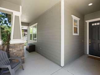 Welcome guests to this charming home with a covered front porch, perfect for enjoying the outdoors.