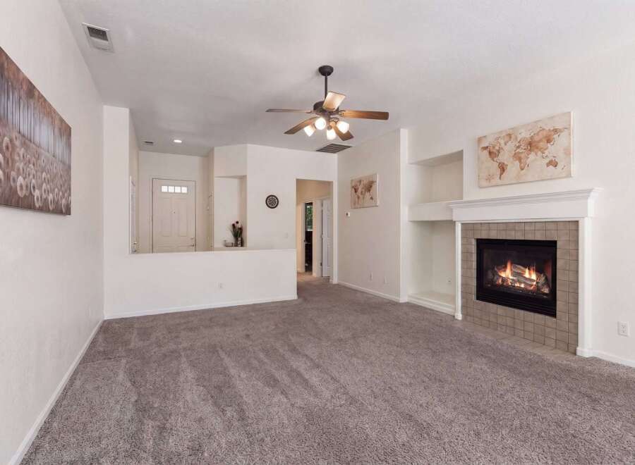 Step into this inviting living room, perfect for cozy evenings by the fireplace.