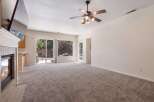 Experience cozy evenings by the fireplace in this inviting living room, featuring a large TV mounted above the mantle.