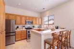 Discover this charming kitchen featuring warm wood cabinetry and a convenient breakfast bar perfect for casual dining.