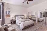 Experience comfort and style in this beautifully appointed bedroom, featuring a plush king-size bed with elegant bedding and a sophisticated upholstered headboard.