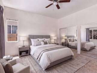 Experience comfort and style in this beautifully appointed bedroom, featuring a plush king-size bed with elegant bedding and a sophisticated upholstered headboard.