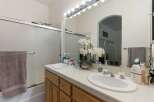 This bright bathroom features a spacious double vanity with two sinks and ample counter space, perfect for busy mornings.