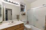 This bathroom features a spacious vanity with a large mirror and ample lighting, perfect for your morning routine.