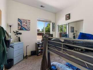 This bedroom features a fun Captain America-themed wall art and a telescope, perfect for a young enthusiast.