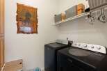 This laundry room features a Maytag washer and dryer set, perfect for handling your family's laundry needs.