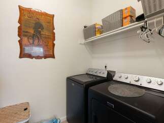 This laundry room features a Maytag washer and dryer set, perfect for handling your family's laundry needs.