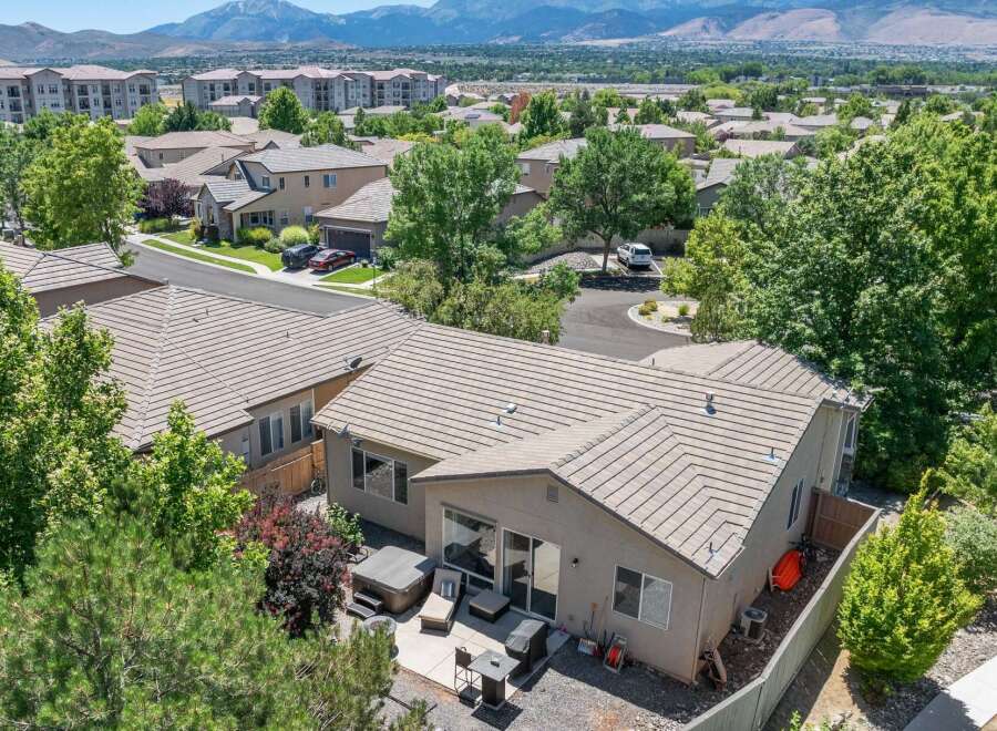 Discover this charming home featuring a spacious backyard with a relaxing hot tub and patio area, perfect for outdoor entertaining.