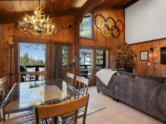 Experience rustic charm and mountain views in this inviting living and dining area.