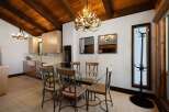 Experience rustic charm in this dining area featuring a striking antler chandelier that illuminates the space.
