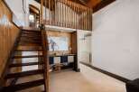 Ascend the charming wooden staircase to discover a unique loft space, perfect for relaxation or creative pursuits.
