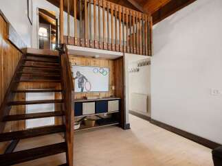 Ascend the charming wooden staircase to discover a unique loft space, perfect for relaxation or creative pursuits.