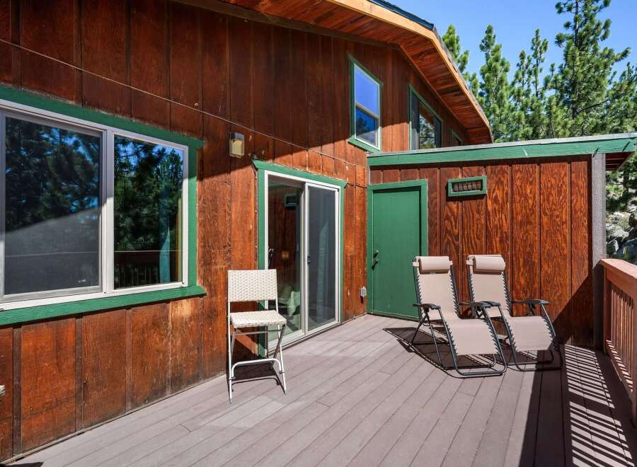 Enjoy the outdoors on this spacious wooden deck, perfect for relaxing or entertaining.