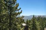 Experience breathtaking panoramic views from this stunning property, nestled amidst lush pine trees.
