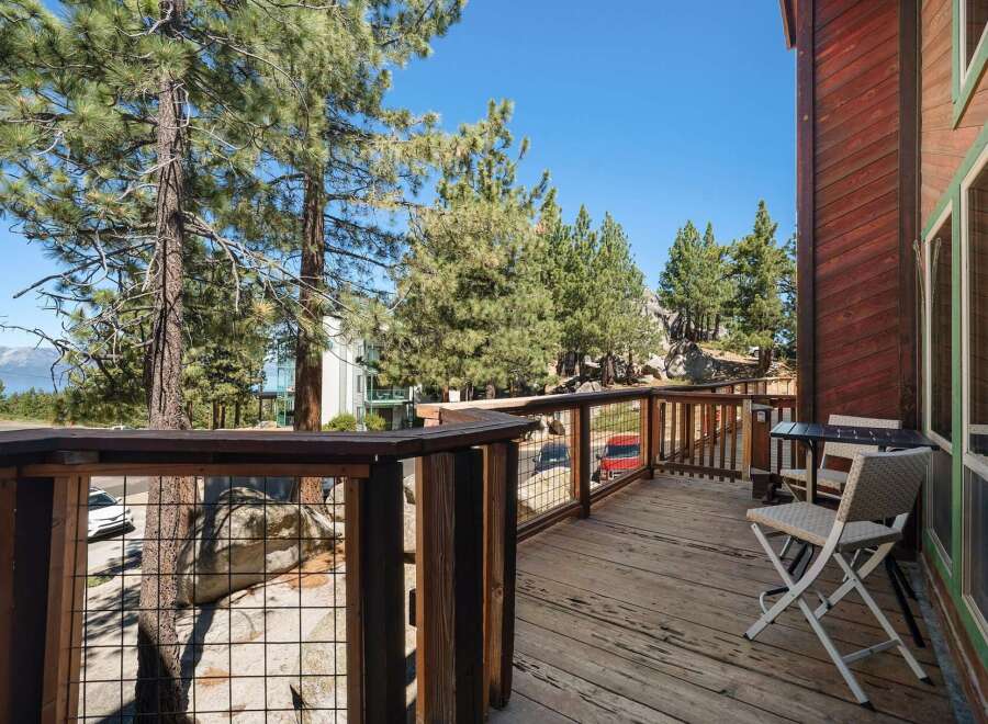 Enjoy breathtaking views from this charming wooden deck, perfect for morning coffee or evening relaxation.