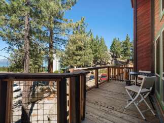 Enjoy breathtaking views from this charming wooden deck, perfect for morning coffee or evening relaxation.