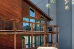 Experience rustic charm and modern comfort in this multi-level wooden cabin, featuring expansive decks with wire railings perfect for outdoor living.
