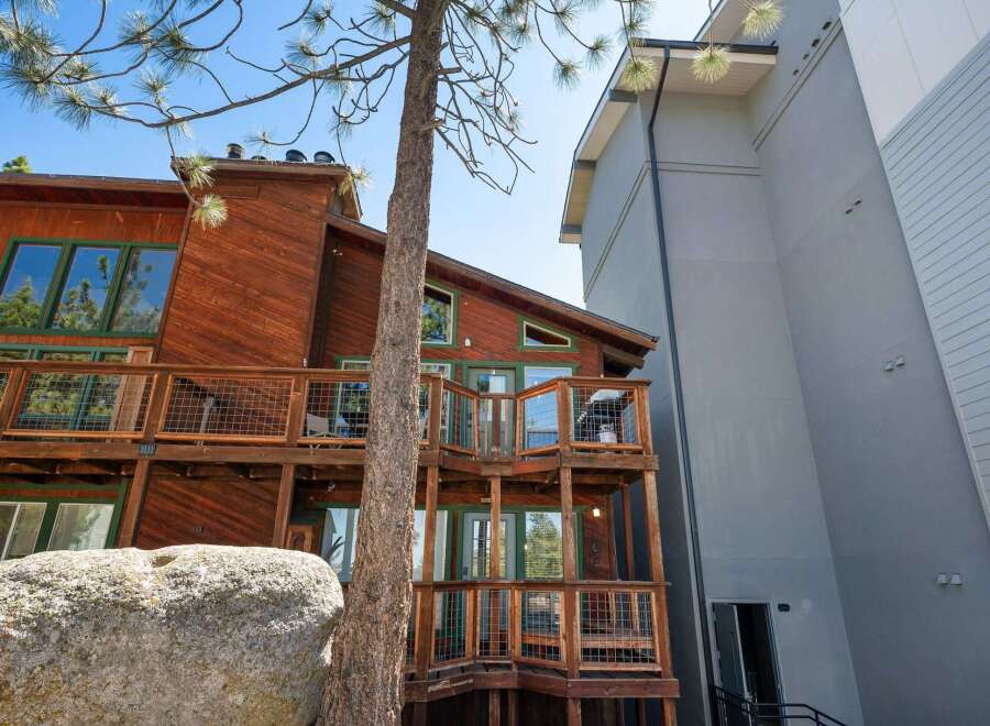 Experience the charm of this rustic wooden home, featuring multiple levels of expansive decks perfect for outdoor living and entertaining.