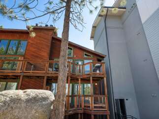 Experience the charm of this rustic wooden home, featuring multiple levels of expansive decks perfect for outdoor living and entertaining.