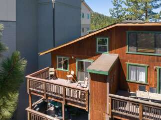 Enjoy outdoor living on this charming wooden deck, perfect for relaxing or entertaining.