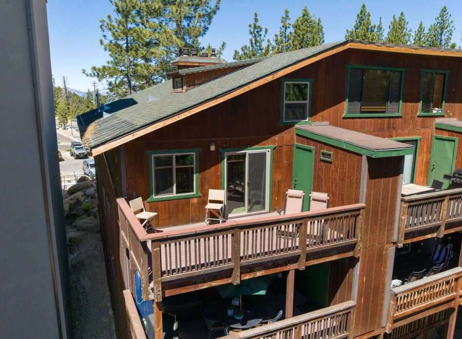 Experience mountain living in this charming wooden cabin featuring multiple levels of outdoor decks perfect for enjoying the fresh air.