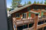 Experience mountain living in this charming wooden cabin featuring multiple levels of outdoor decks perfect for enjoying the fresh air.