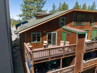 Experience mountain living in this charming wooden cabin featuring multiple levels of outdoor decks perfect for enjoying the fresh air.