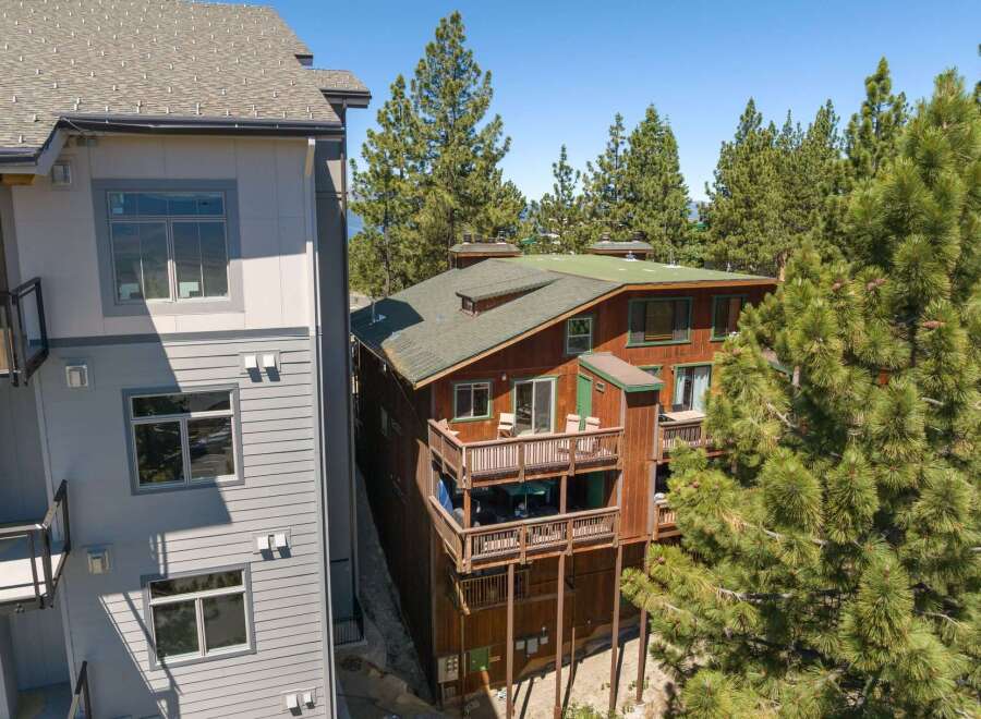 Experience mountain living in this charming wooden home, featuring multiple levels of expansive decks perfect for enjoying the surrounding pine forest.