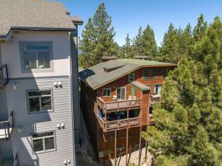 Experience mountain living in this charming wooden home, featuring multiple levels of expansive decks perfect for enjoying the surrounding pine forest.