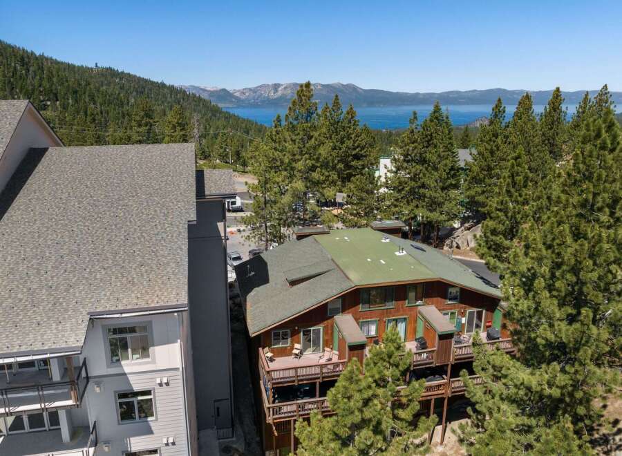 Experience breathtaking lake and mountain views from this stunning property, nestled amidst lush pine trees.