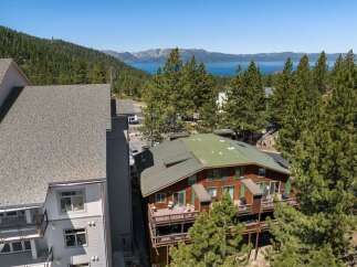 Experience breathtaking lake and mountain views from this stunning property, nestled amidst lush pine trees.