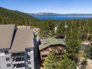 Experience breathtaking lake and mountain views from this stunning property, nestled amidst a lush pine forest.
