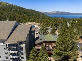 Experience breathtaking lake and mountain views from this stunning property, nestled amidst a lush pine forest.